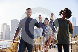 Young family taking a walk on footbridge, close up