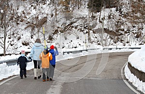 Young family with three children walking photo