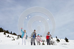 Young Family Throwing Snowballs photo