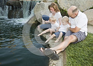 Young Family with Twins Enjoy Water in Park