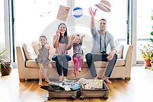 Young family with two children packing for holiday.