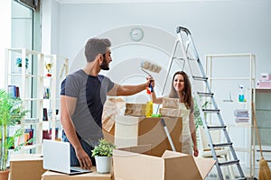 The young family unpacking at new house with boxes