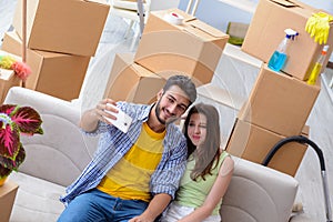 The young family unpacking at new house with boxes