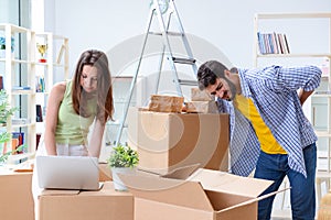 The young family unpacking at new house with boxes