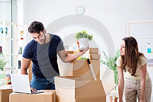 The young family unpacking at new house with boxes