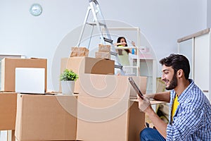 The young family unpacking at new house with boxes