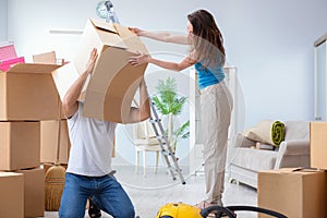 The young family unpacking at new house with boxes