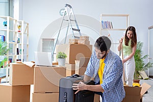 The young family unpacking at new house with boxes