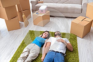 The young family unpacking at new house with boxes