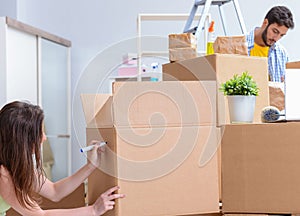 Young family unpacking at new house with boxes