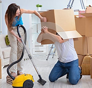 Young family unpacking at new house with boxes