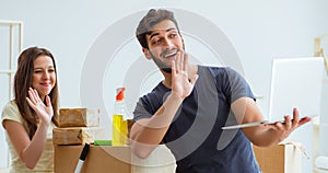 Young family unpacking at new house with boxes