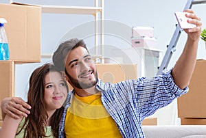 Young family unpacking at new house with boxes