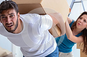 Young family unpacking at new house with boxes