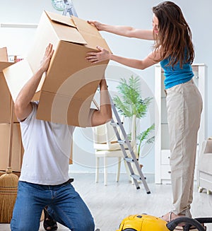 Young family unpacking at new house with boxes