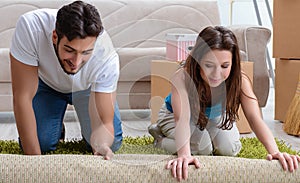 Young family unpacking at new house with boxes