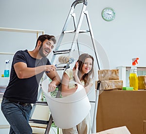 Young family unpacking at new house with boxes