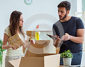 Young family unpacking at new house with boxes