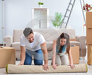 Young family unpacking at new house with boxes