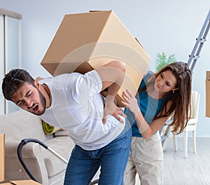 Young family unpacking at new house with boxes