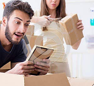 Young family unpacking at new house with boxes