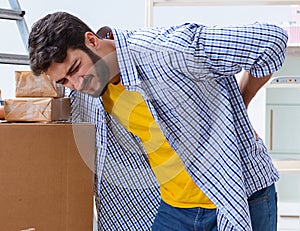 Young family unpacking at new house with boxes