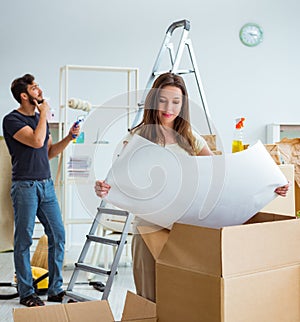 Young family unpacking at new house with boxes