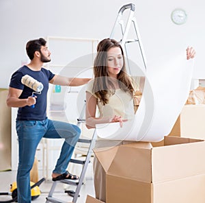 Young family unpacking at new house with boxes