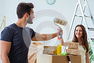 Young family unpacking at new house with boxes