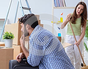 The young family unpacking at new house with boxes