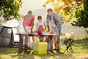 Young family on vacation having barbecue