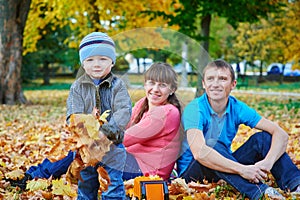 Young family walking in autumn park