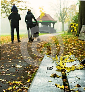 Young Family Walking Through Harrow Parkin in Autumn