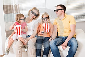 Young Family Watching 3D TV
