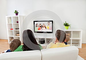 Young family watching TV photo