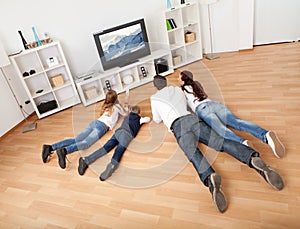 Young family watching TV at home