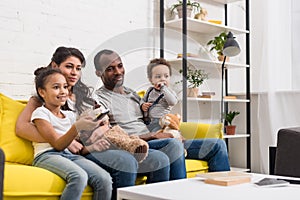 young family watching tv together