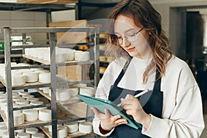 Young Farm Female Owner Controls Maturing Process of Goat Cheese Heads