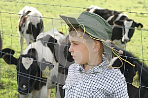 Young farmer amongst dairy cows