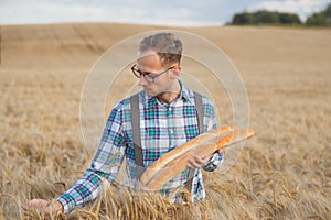 Young farmer or baker portrait in field
