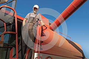 Young farmer on a break in combine