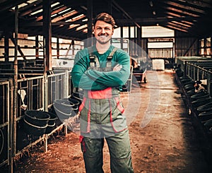 Young farmer in a cowshed on a dairy farm photo