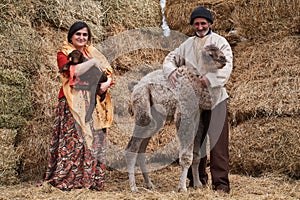 Young farmer man and woman with Camel and lamb at the farm