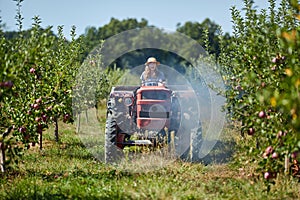 Young farmer woman driving her old tractor