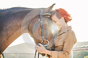 Young farmer woman hugging her horse - Concept about love between people and animals - Focus on girl eye