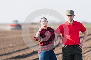 Young farmers examing planted wheat fields photo