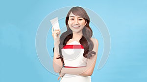 Young fashion Asian woman model present showing cosmetic make up package products empty copy space on her hand palm