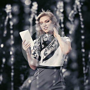 Young fashion blond business woman using digital tablet computer