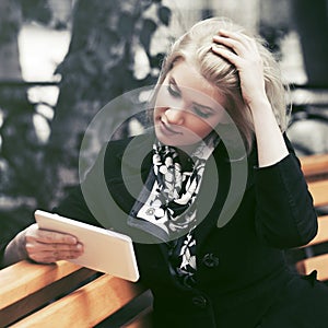Young fashion blond business woman using digital tablet computer