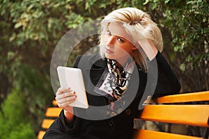 Young fashion blond business woman using digital tablet computer